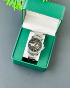Silver watch in a green box on a gray background