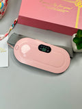 Pink electronic device on a gray surface with a gift box in the background